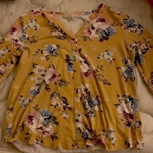 A flowered blouse with a yellow dark shade size medium